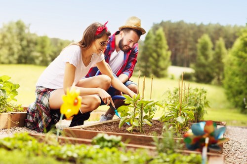 Front view of a gardener inspecting a garden bed